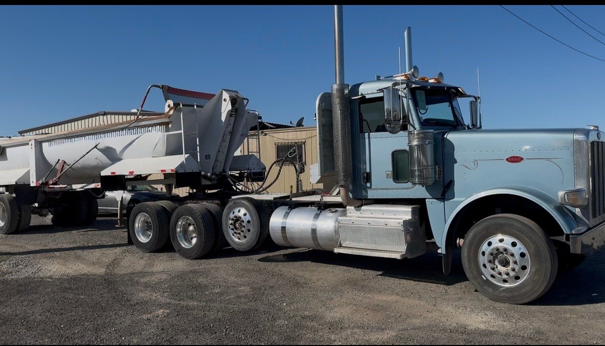 Los De La V Trucking truck hauling material